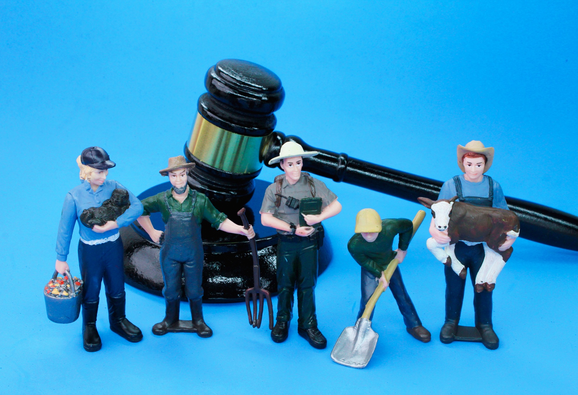 judge's hammer and laborer miniatures. the concept of labor laws.