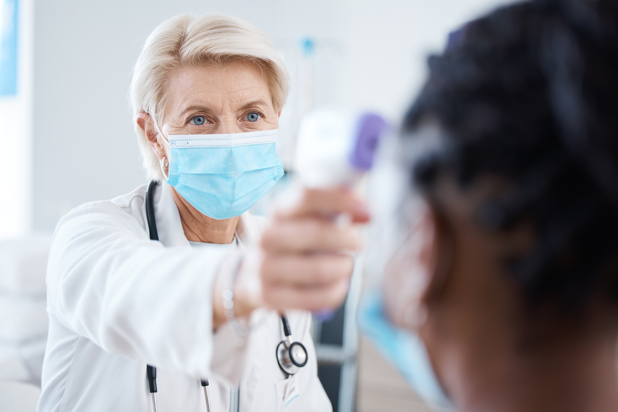 Medical, covid and temperature with doctor and woman for prevention, treatment and diagnosis. Healt