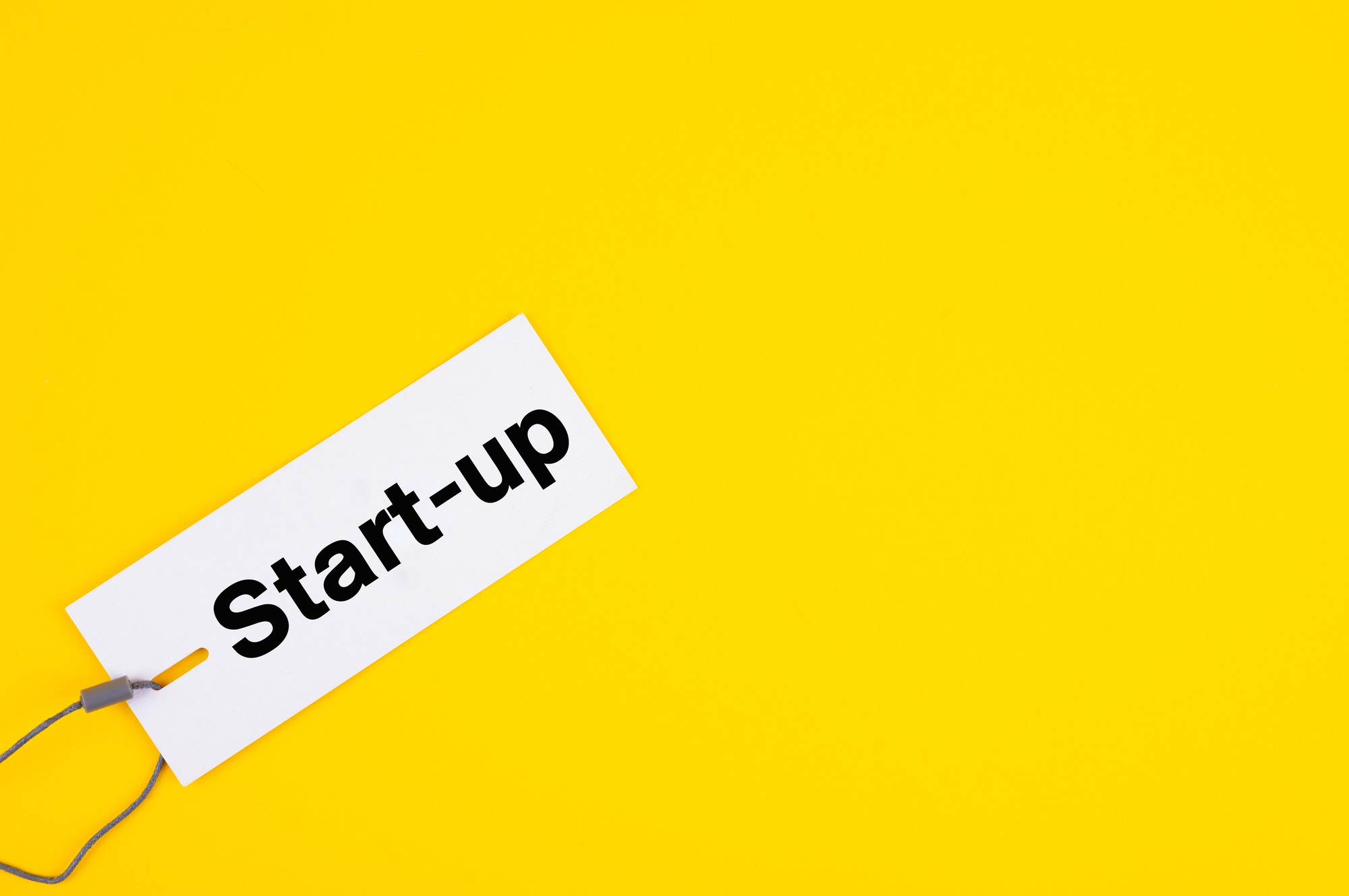 Top view of a label tag with the writing "Start-up" - company formation as a product label concept