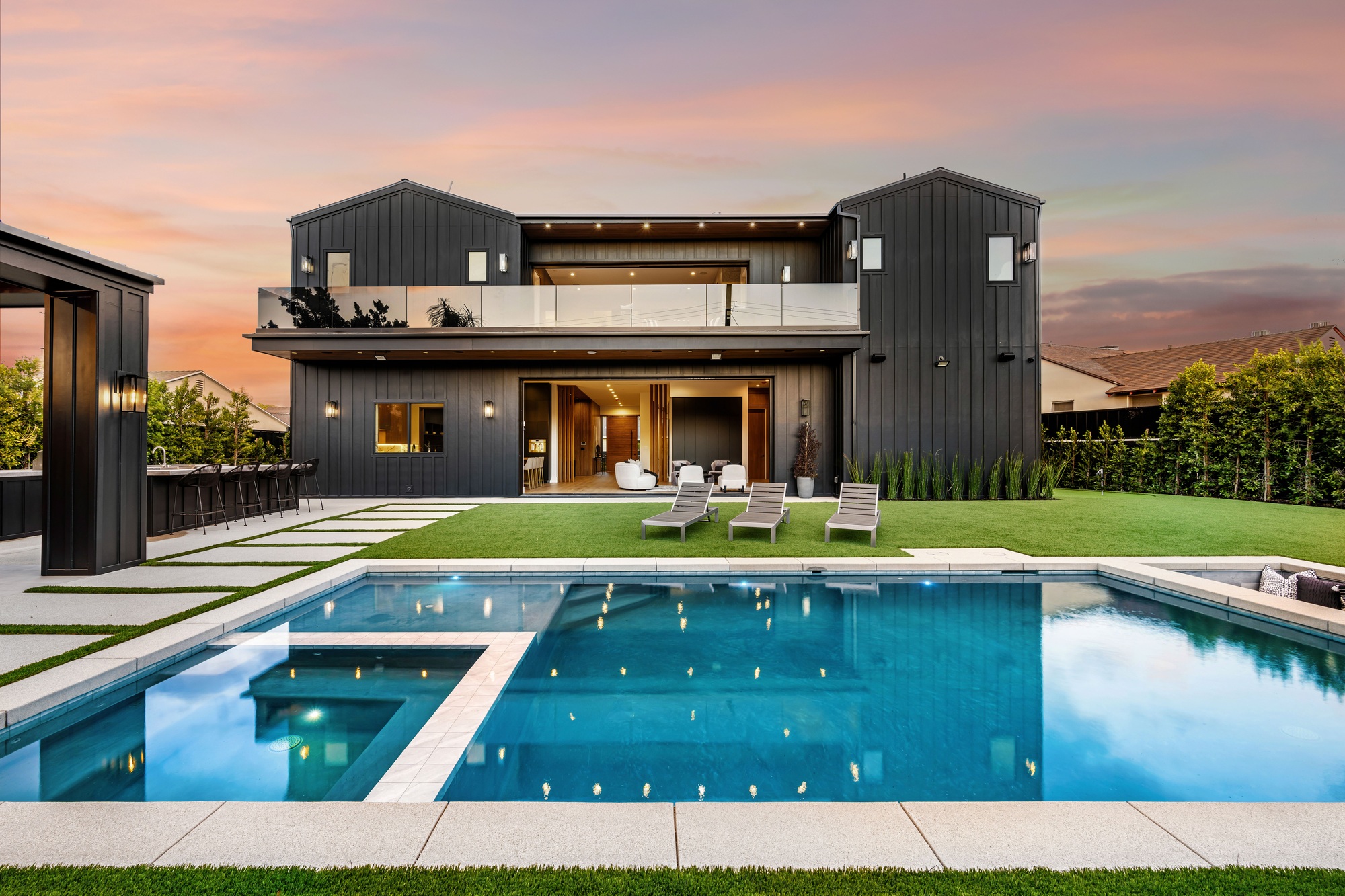 Modern luxury house with swimming pool at sunset
